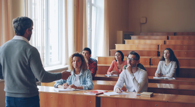 Students listening to a professor in a lecture hall